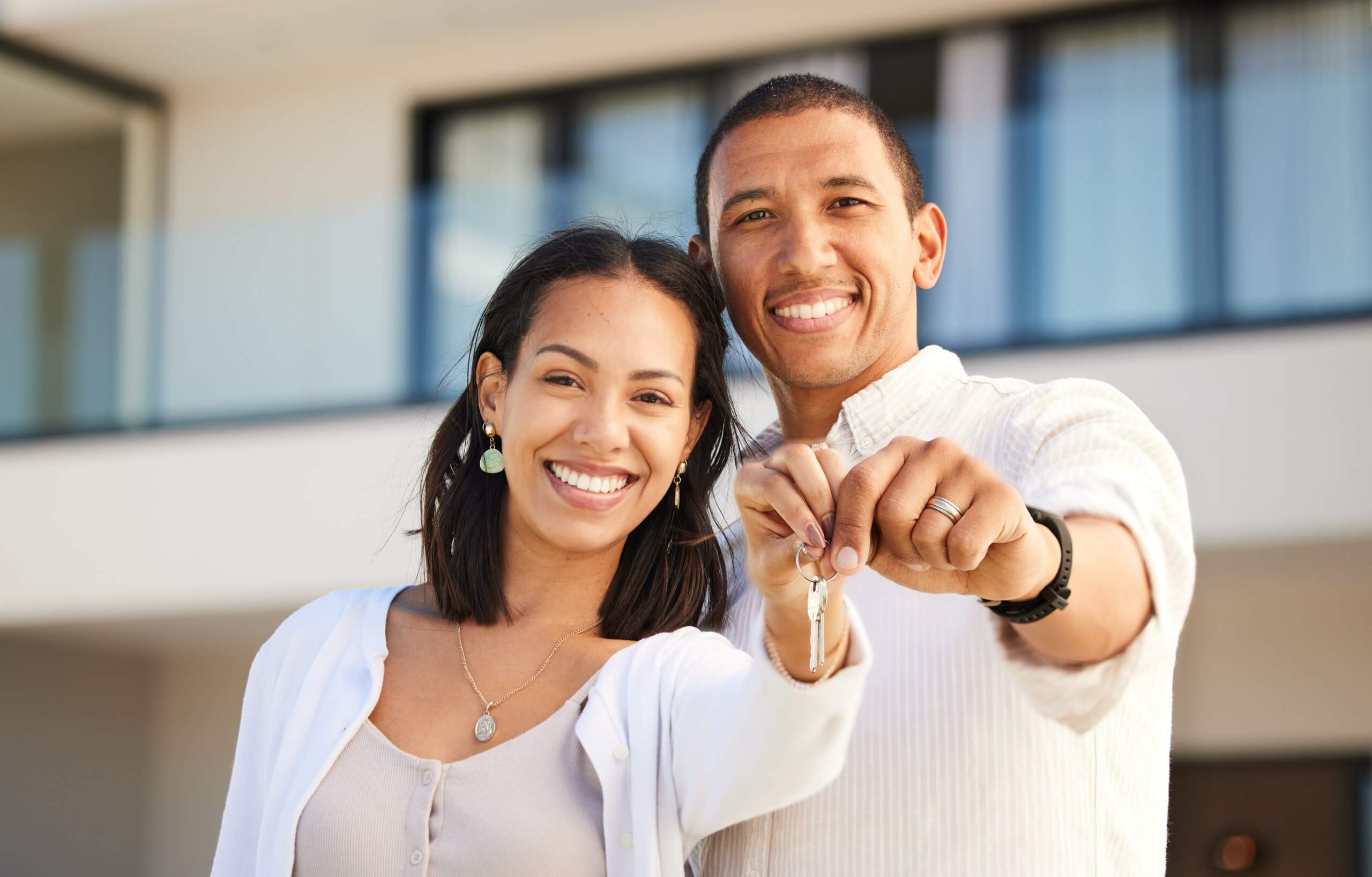 happy-couple-portrait-holding-keys-house-with-smile-relationship-goals-marriage-together-excited-man-woman-homeowners-smiling-with-key-moving-real-estate-new-home